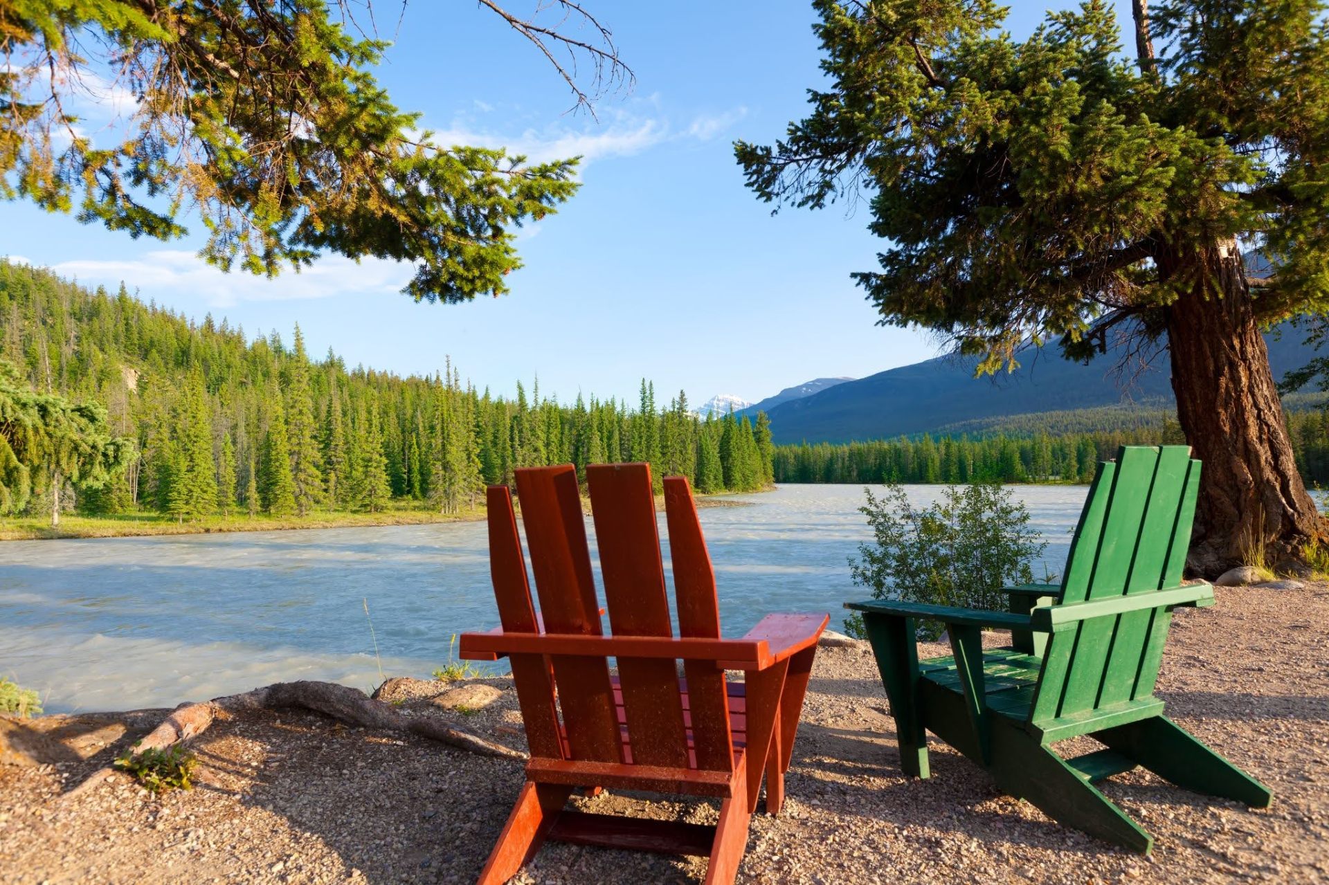 Canadian landscape with Adirondack chairs by river