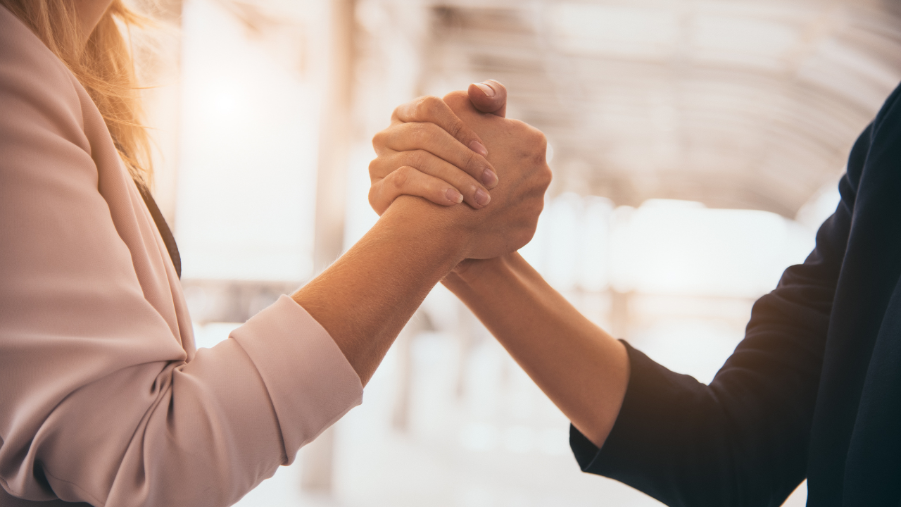 Business partners shaking hands in agreement