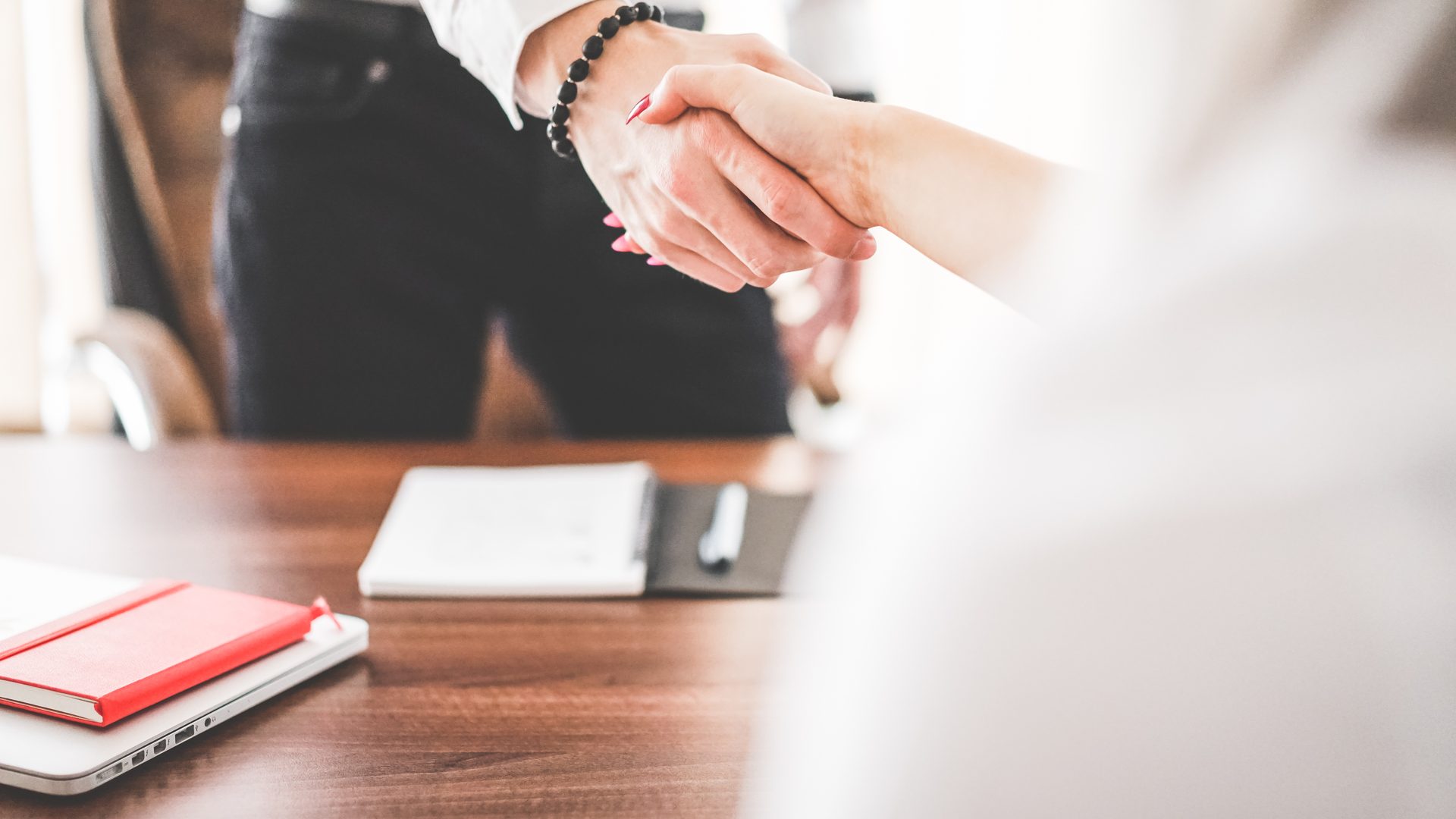 Business man and woman handshake in work office