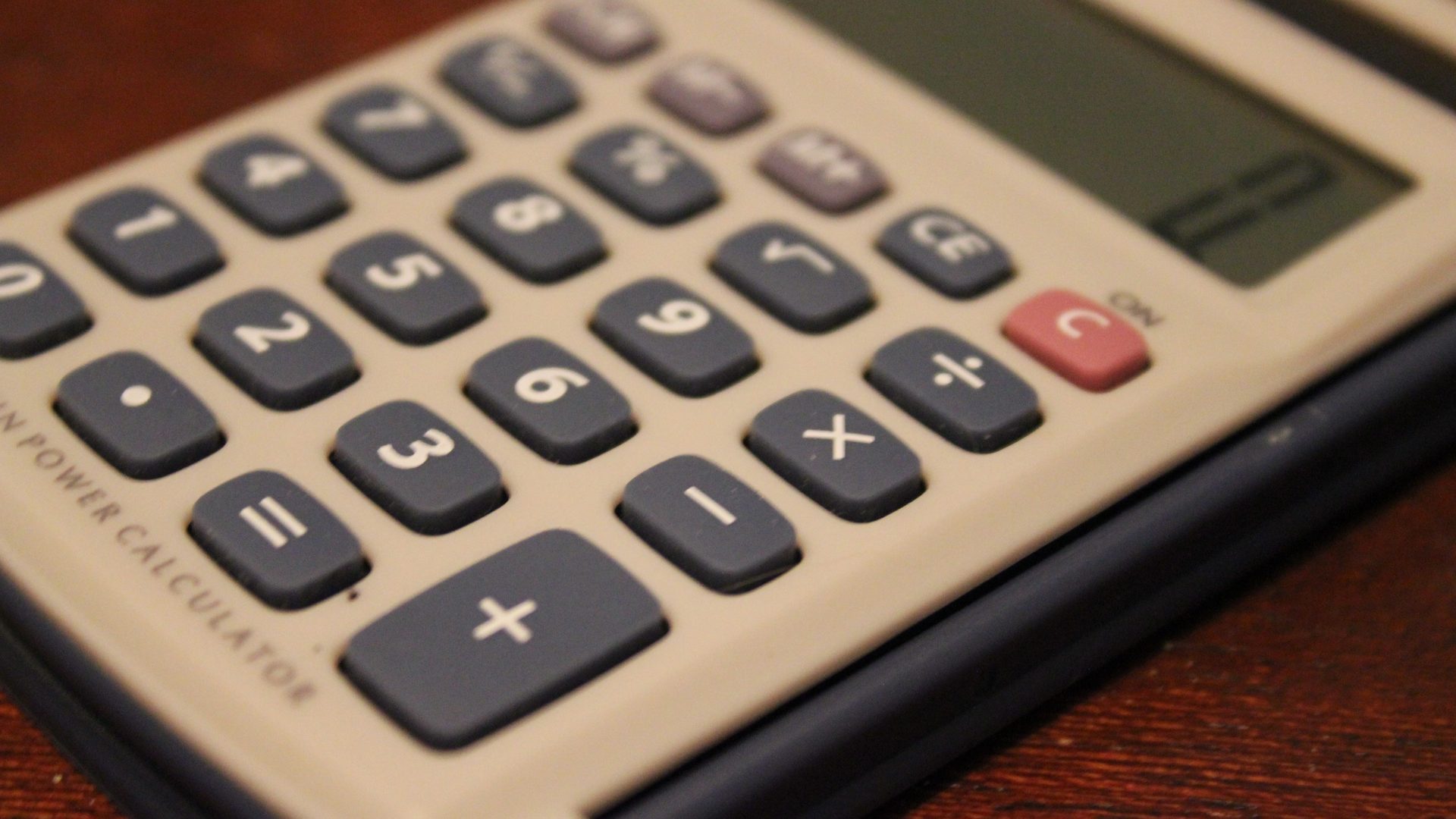 Calculator and paperwork representing deemed disposition tax calculations