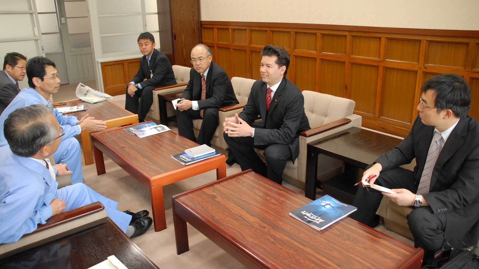 Two professionals in a business meeting discussing wealth strategy
