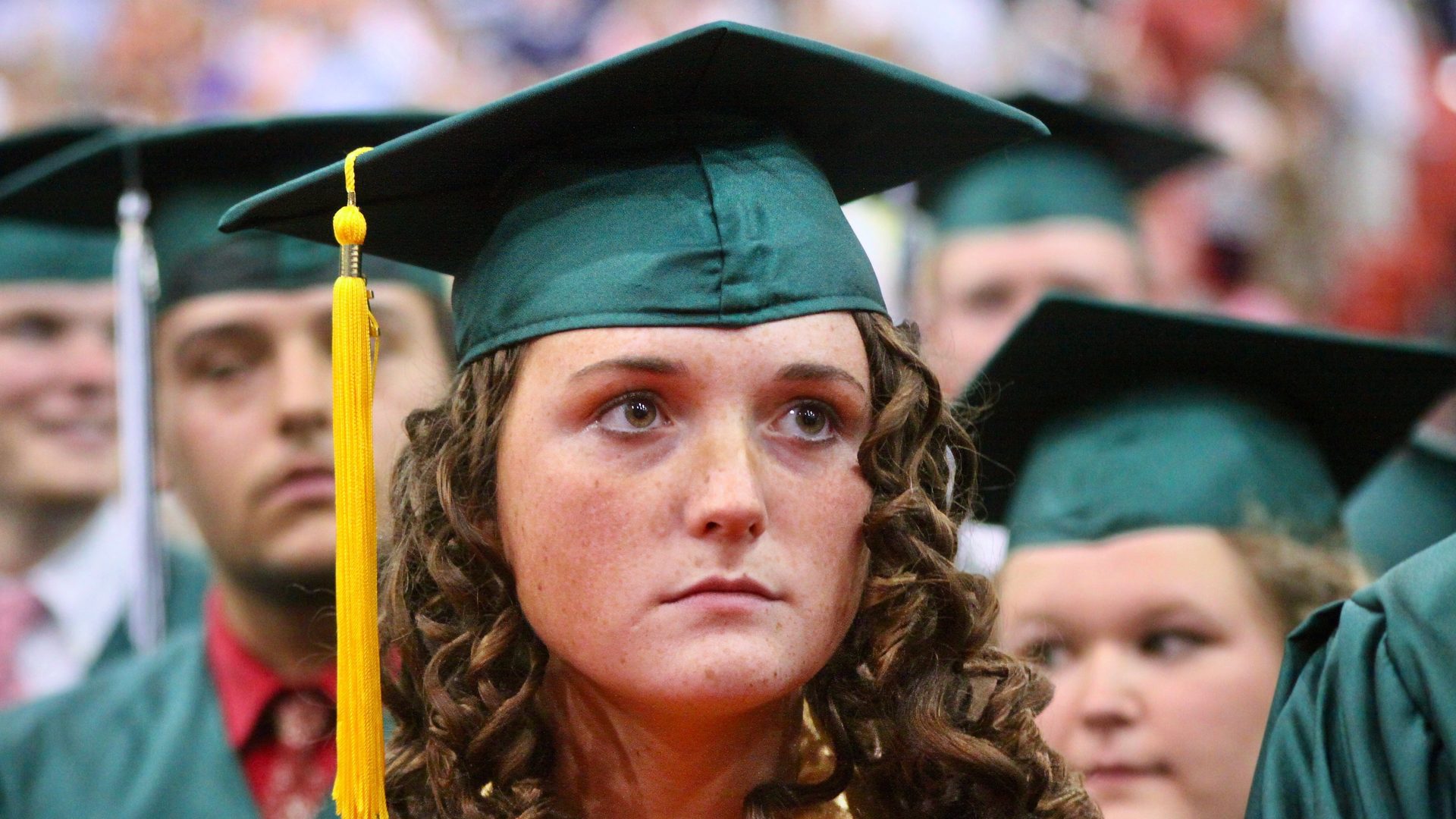 A high school graduate at a graduation ceremony