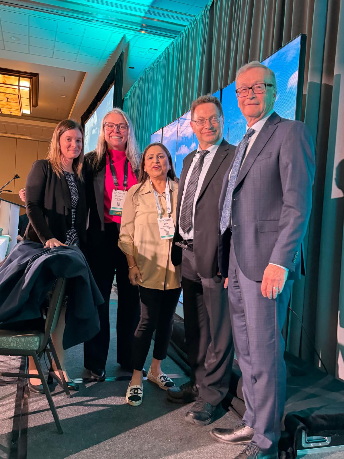 Sim Gakhar with fellow panelists at a Canadian financial conference